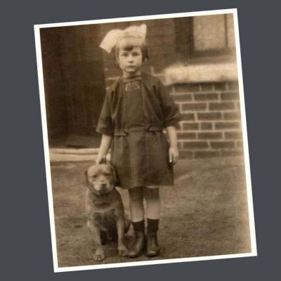 Child-with-dog-in-front-of-bungalow