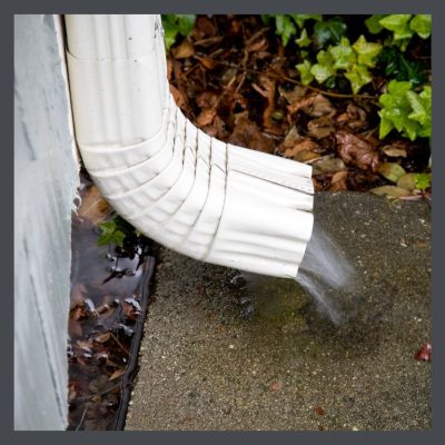 Gutter-pouring-water-onto-bungalow's-foundation