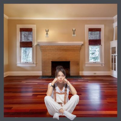 Woman figuring out how to decorate a bungalow living room.